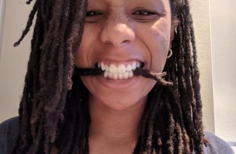 woman with two headed loc in her mouth
