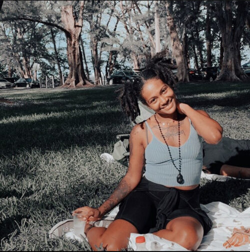 woman with pigtail locs outside in park